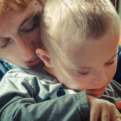 Madre abrazando a su hijo con discapacidad.